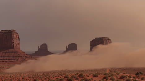 dust storm amidst red rock buttes in a desert landscape