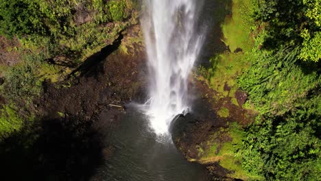 Close-up-of-the-end-of-a-cascade-flowing-to-natural-pool