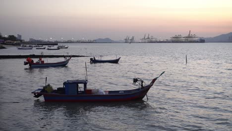 Fishing-boat-with-background-container-terminal