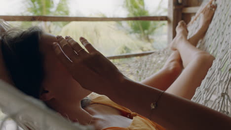 happy-woman-in-hammock-enjoying-comfortable-lifestyle-on-holiday-in-vacation-resort-swaying-peacefully-on-lazy-summer-day-in-tropical-paradise-cabin