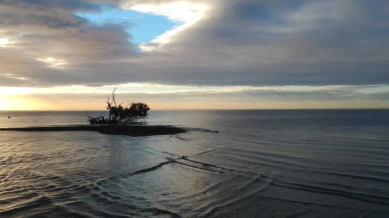 Early morning at the beach at sunrise with views of the island and estuary