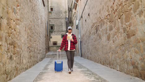 traveling man with suitcase checking map