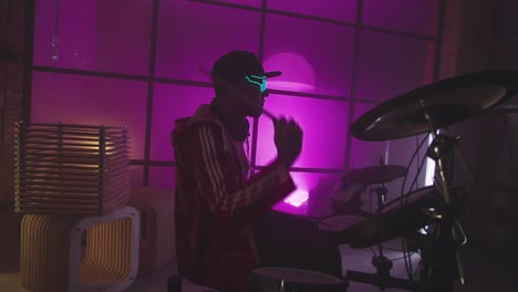 neon drummer in a trendy music studio