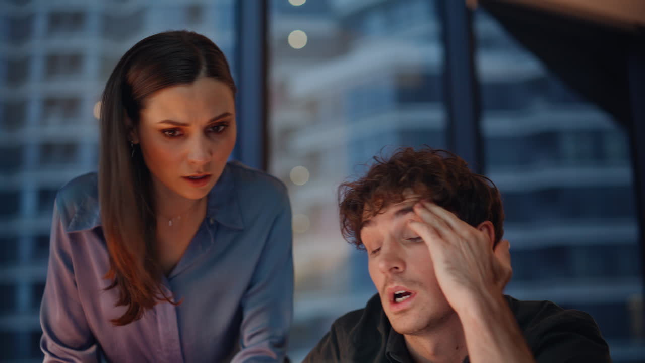 Woman manager checking trainee working late at office laptop worried closeup