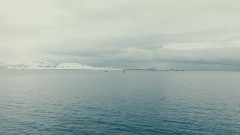 fishing boat in the sea during winter in norway. - aerial shot