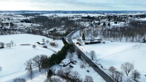 Curvy-road-winds-through-snow-covered-valley-in-USA-winter