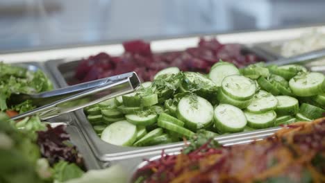 pan right, colourful salads in a salad bar window display