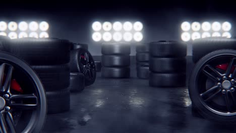 stacks of racing tires and wheels in a dark garage