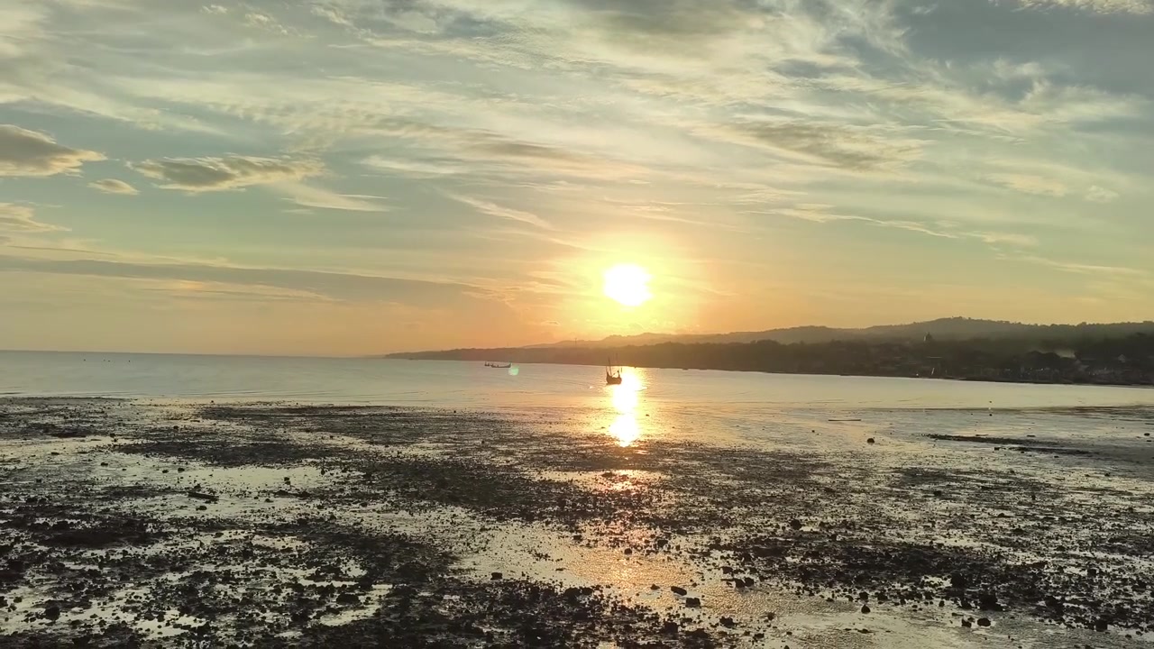 Golden Sunset Over Calm Sea with Reflection on Shore