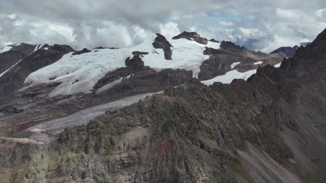 majestic snow-capped mountains and glaciers under a cloudy sky