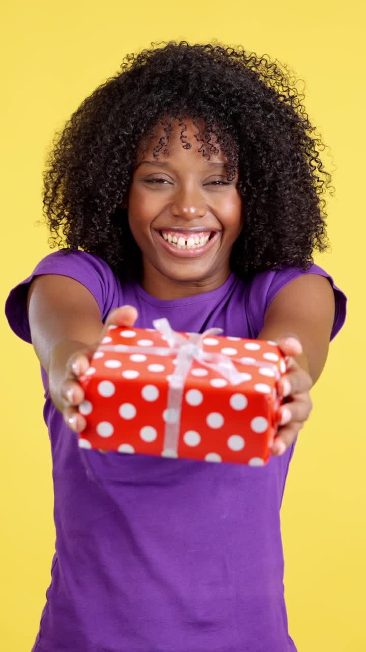 Joyful Woman with Curly Hair Presenting a Gift