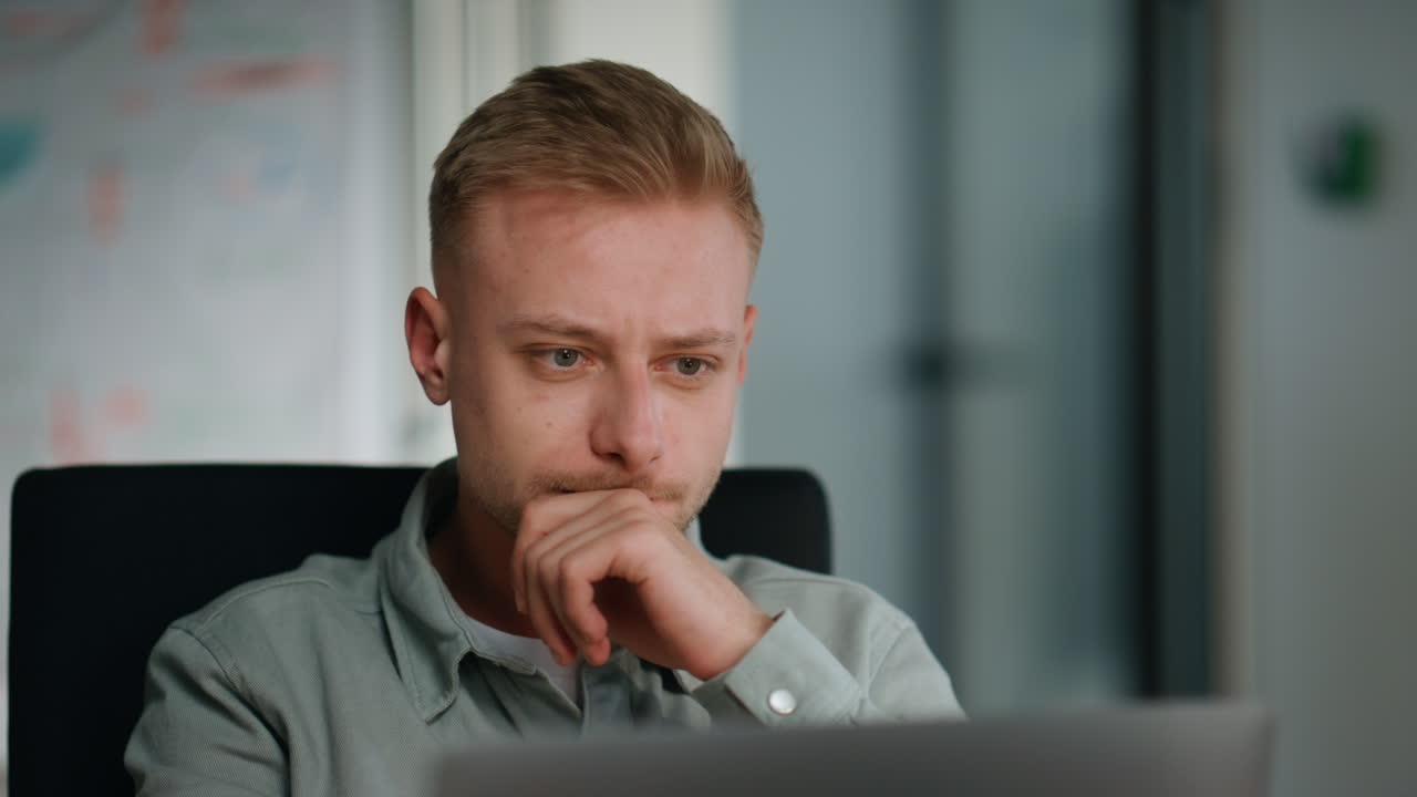 Man manager planning project sitting workspace closeup. Young man looking laptop