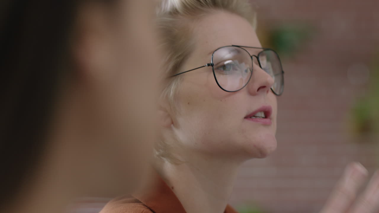 retrato profesional mujer de negocios caucásica discutiendo ideas creativas hermosa gerente de oficina compartiendo conversación usando gafas en un lugar de trabajo moderno de inicio de cerca