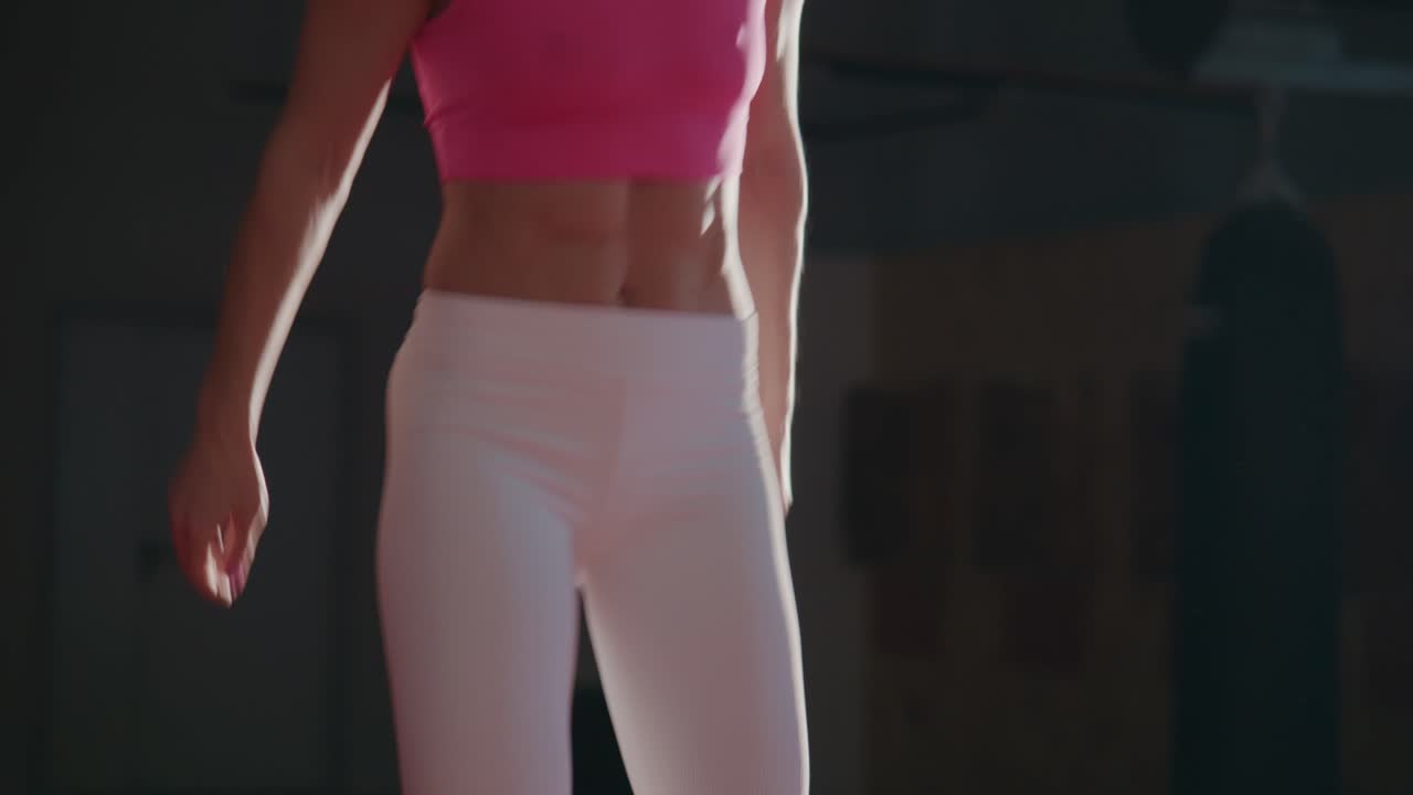 Energetic Woman Performing Dynamic Workout Exercises in a Gym
