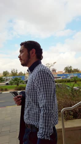 businessman leaving the entrance to an office building