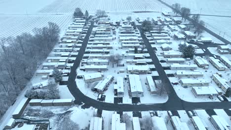 large rural mobile home trailer houses covered in winter snow