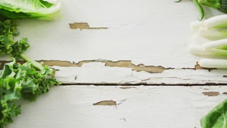 video of fresh salad leaves with copy space on white rustic background