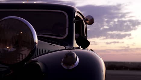 Close-Up-Shot-Of-Unique-Vintage-Car,-Driver-Waiting-For-Bride-And-Groom-At-Wedding-sunset