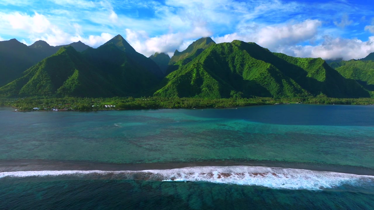Teahupo'o surf wave waves aerial drone harbor view Tahiti village of town lagoon End of the Road French Polynesia island sunny blue sky lagoon surfing Passe Havea coral reef landscape right motion