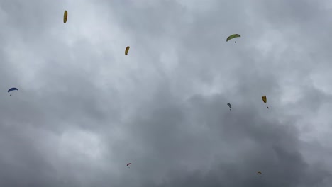 group of people gliding competition, spectacular flight high in cloudy sky