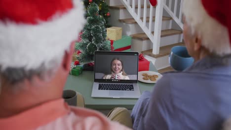Happy-african-american-senior-couple-on-video-call-with-granddaughter-at-christmas