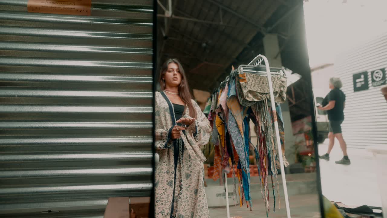Woman at an urban market fashion stand