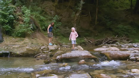 mother and son hiking along a mountain stream