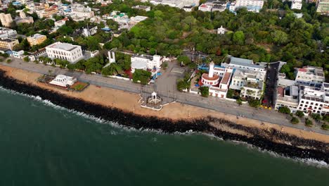 early morning aerial video captures the city and the mahatma gandhi statue from the water. puducherry lighthouse. there are waves in the bay of bengal. rock beach and parallax shot of french colony