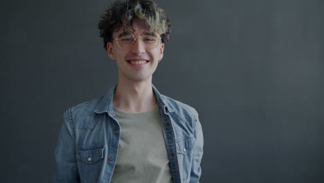 happy young man raising arms