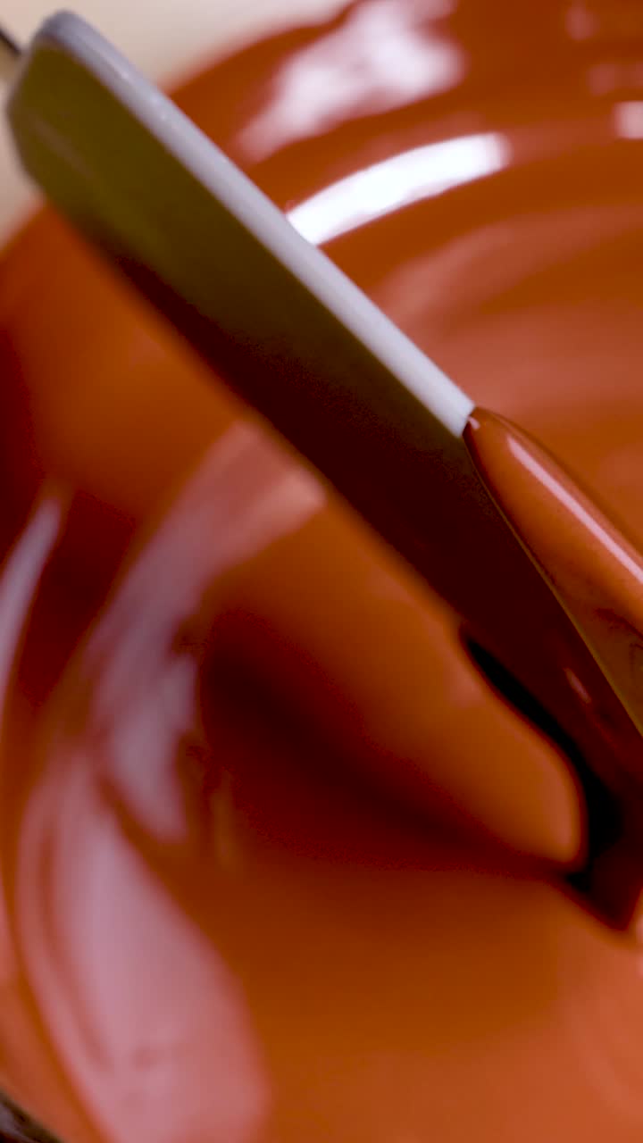 Smooth chocolate stirred with a spatula
