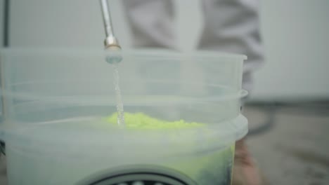 pressure-Washer-Gun-filling-bucket-with-water-and-soap