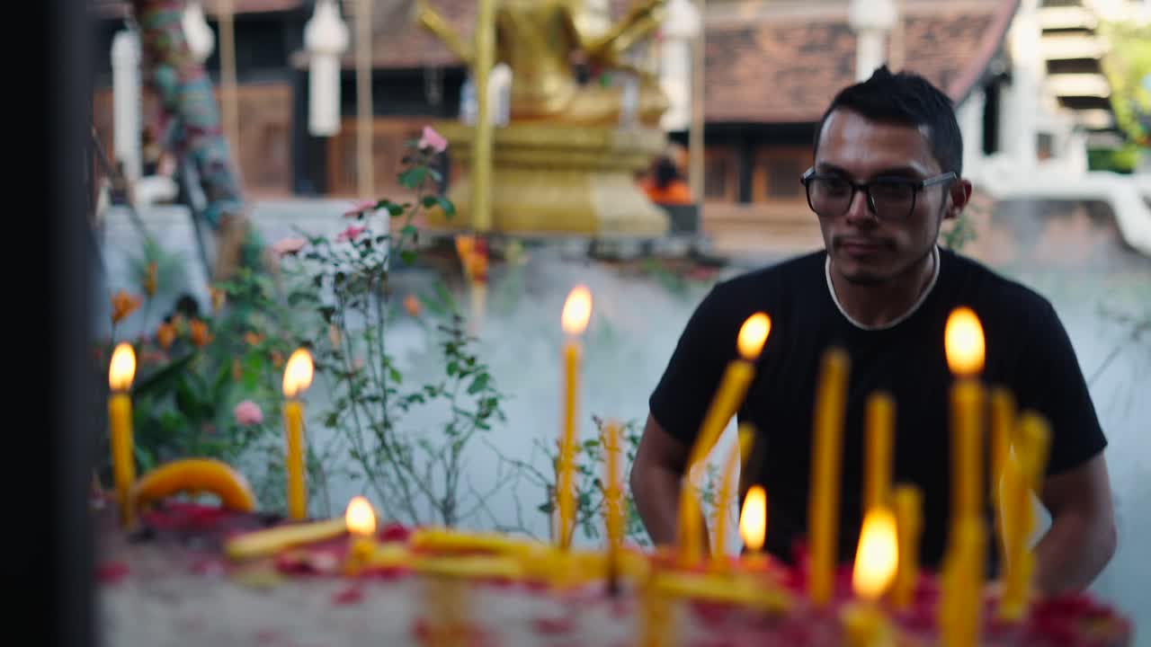Man Praying at a Temple in Thailand