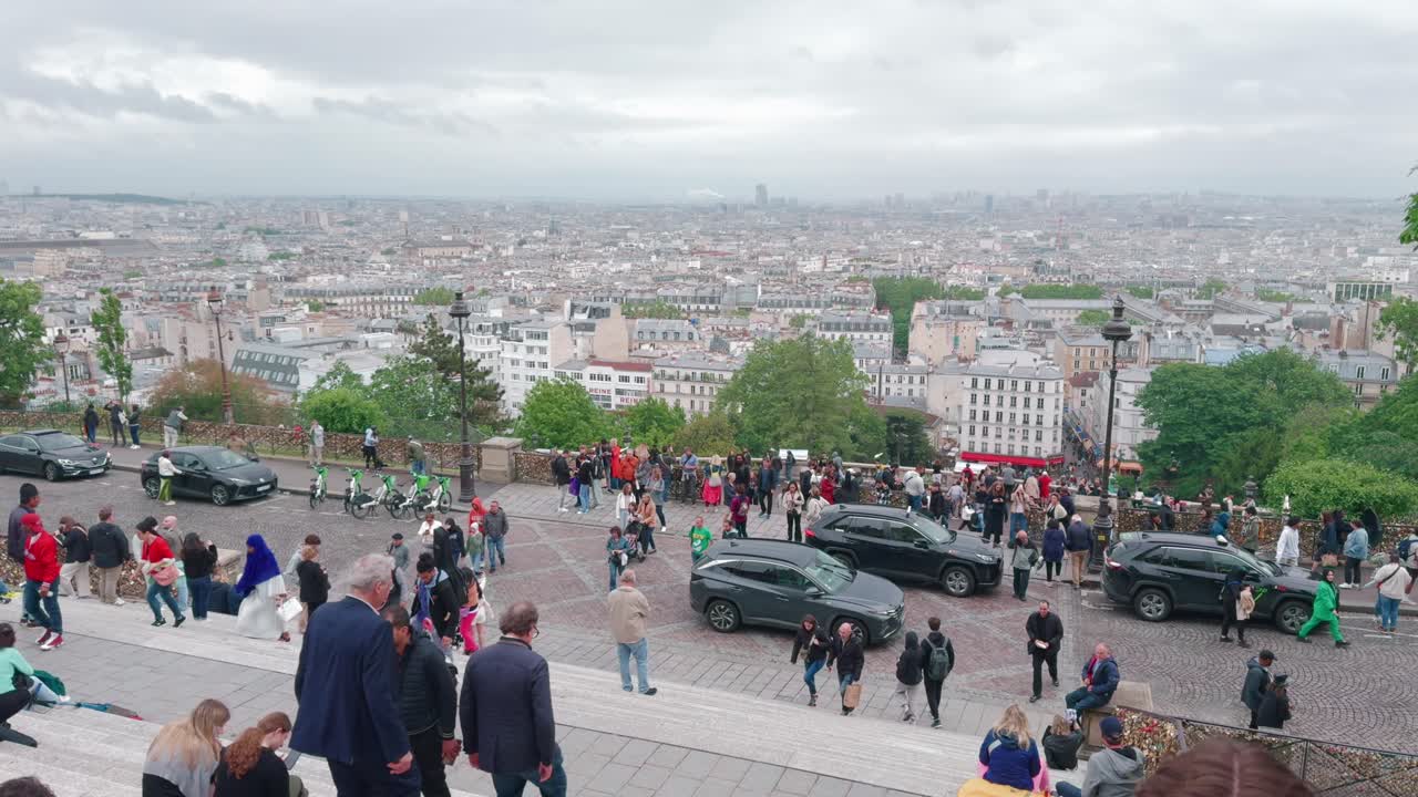 Tourists on the Montmartre Steps Overlooking the City of Paris