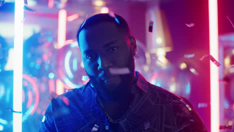 African-american-man-looking-at-camera-at-party.-Guy-sending-air-kisses-in-club