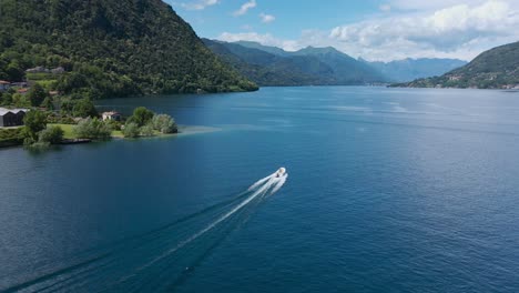 aerial shot of a boat sailing on the lake of pella, in piedmont, italy