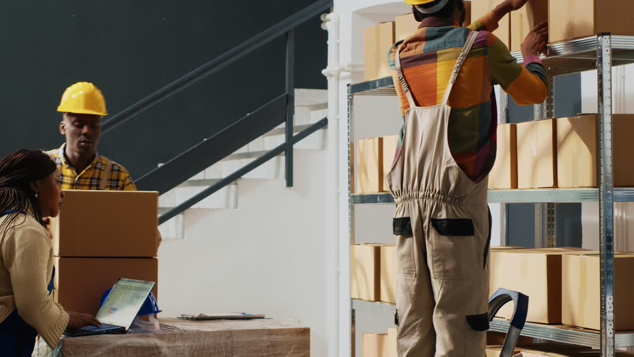 Warehouse workers organizing boxes in storage facility