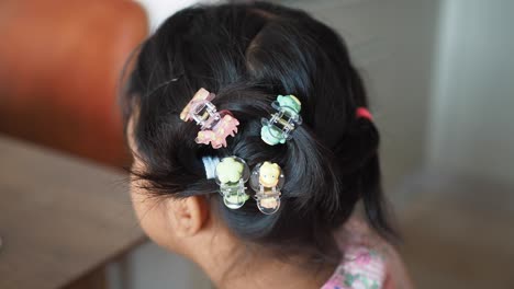 child with colorful hair clips