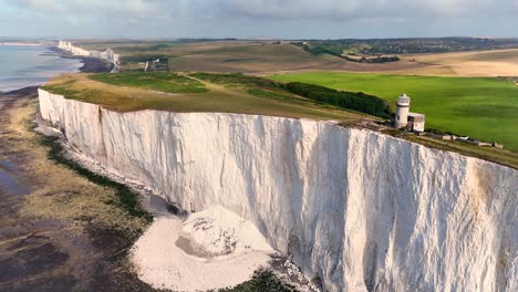 the belle tout lighthouse situated on the edge of the beautiful seven sisters chalk cliffs and stunning green fields