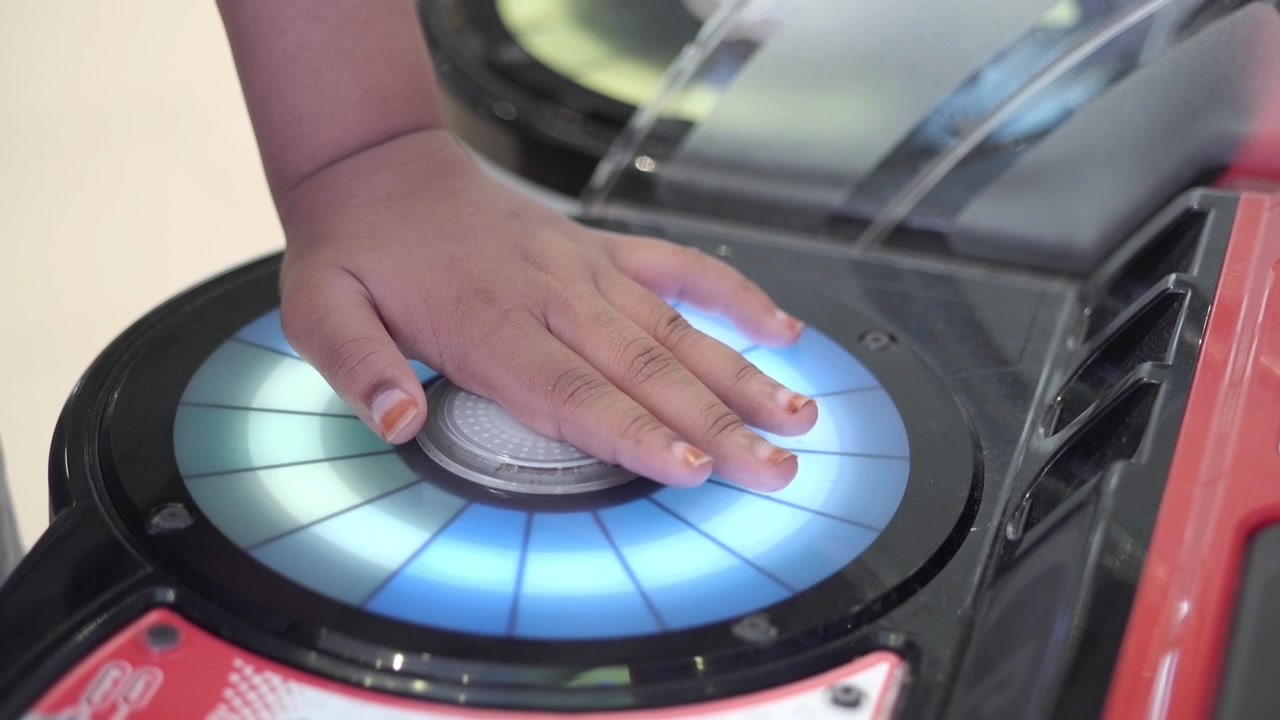 Child Playing Interactive Light Game at Arcade