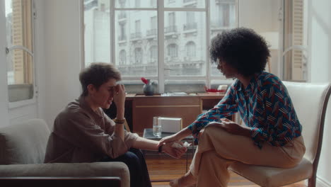 therapist supporting stressed female patient during consultation