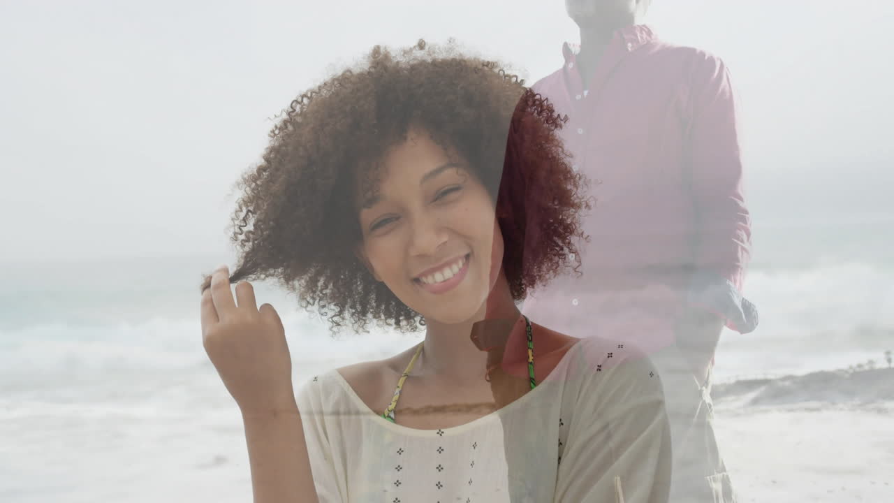 Walking along shoreline, man overlays smiling woman at beach in animation