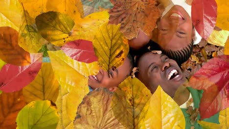 Animation-of-autumn-leaves-falling-over-happy-african-american-family-in-park