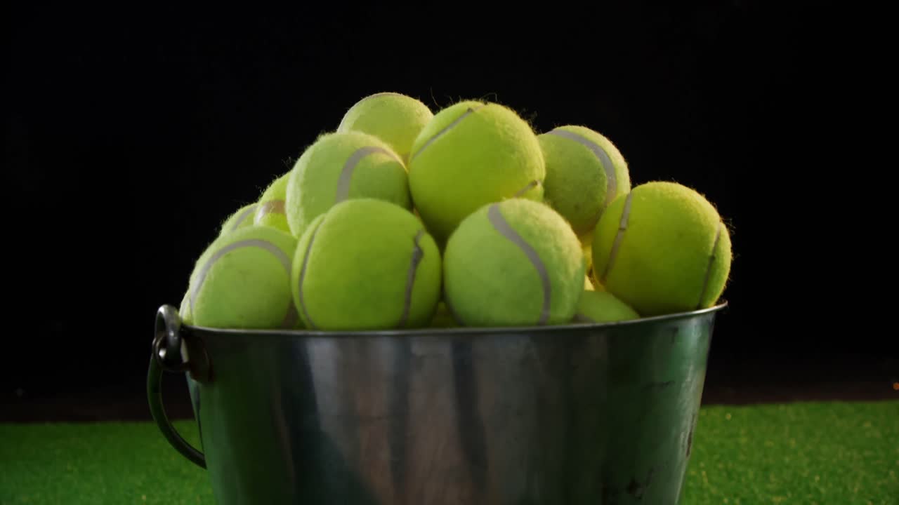 Tennis balls in bucket at studio 4k