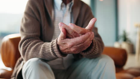 close up of an elderly man with painful hands due to arthritis