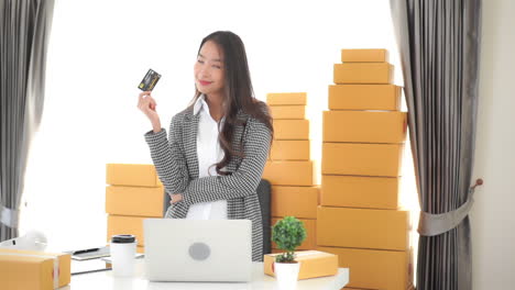 holding a black and gold credit card a young businesswoman thinks about what comes next