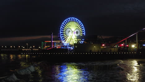 santa monica pier at night with ferris wheel