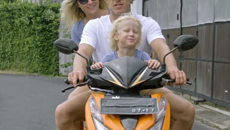 family enjoying scooter journey with pet