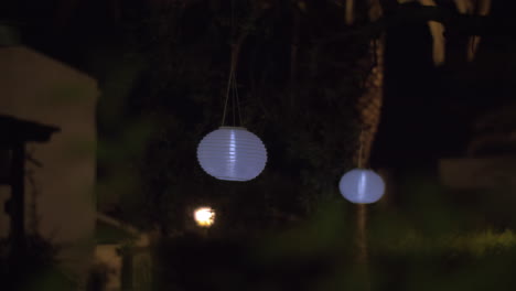 House-garden-with-white-paper-lanterns-at-night