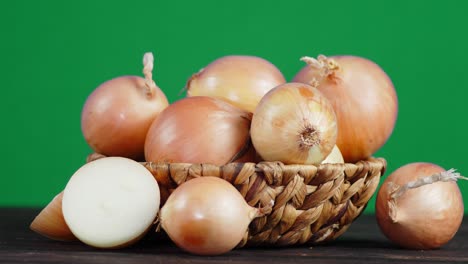 unpeeled onions in the basket slowly rotates.