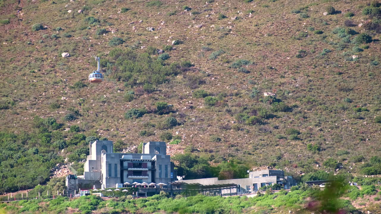 Cable car descends toward lower station at popular Table Mountain attraction